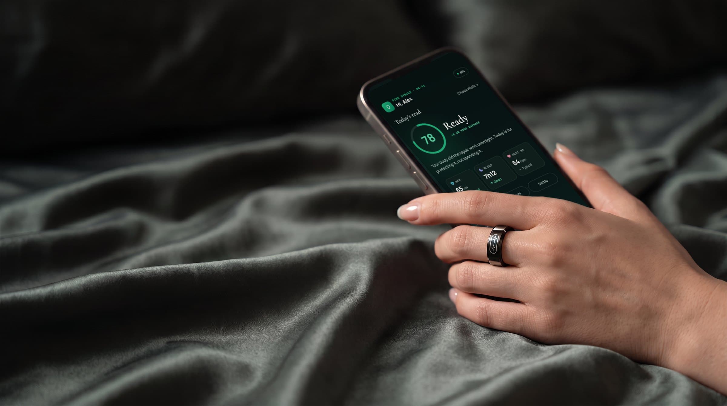 A hand wearing PRANA ring holds a phone showing the Vyana morning status